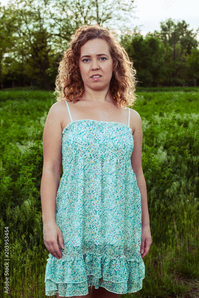 Portrait of a beautiful woman near the field on a farm. Portrait of a beautiful woman near the field on a farm.