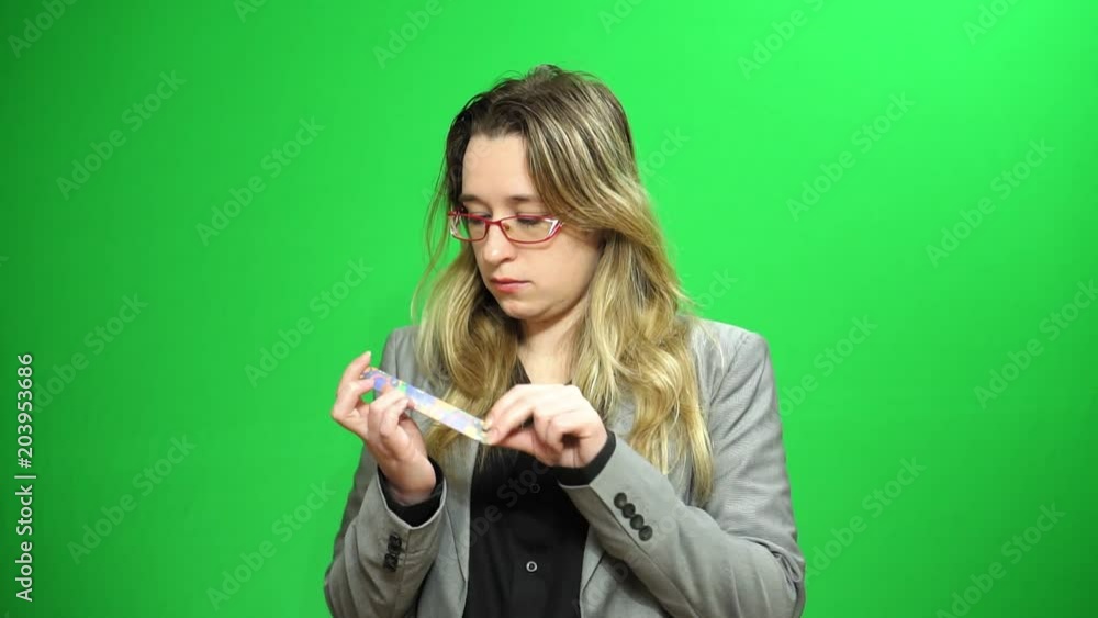 A young girl is engaged in caring for her hands. Green background of the screen. A young girl is engaged in caring for her hands. Green background of the screen.