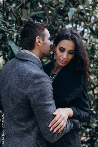 Fashion engagement shooting, photo session for beautiful couple, walk of a couple in love around the city and park. © dimadasha