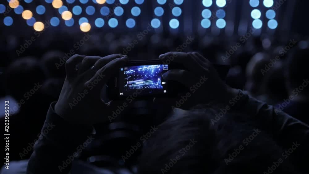 Audience recording video of band on mobile phone in concert. Audience recording video of band on mobile phone in concert.