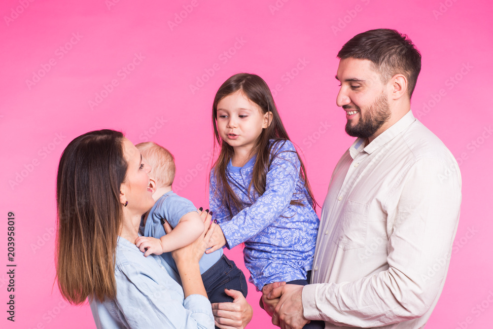 Happy mixed race family portrait smiling on pink background Happy mixed race family portrait smiling on pink background