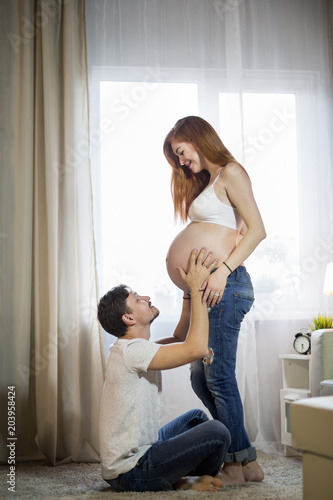 Husband and pregnant wife in a room
