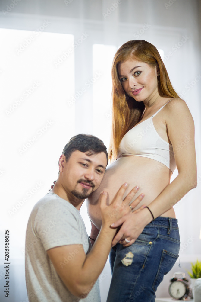 Husband and pregnant wife in a room Husband and pregnant wife in a room