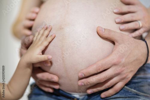 Husband and pregnant wife in a room