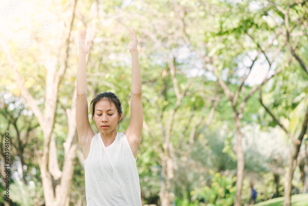 Young asian woman yoga outdoors keep calm and meditates while practicing yoga to explore the inner peace. Yoga and meditation have good benefits for health. Yoga Sport and Healthy lifestyle concept. Young asian woman yoga outdoors keep calm and meditates while practicing yoga to explore the inner peace. Yoga and meditation have good benefits for health. Yoga Sport and Healthy lifestyle concept.