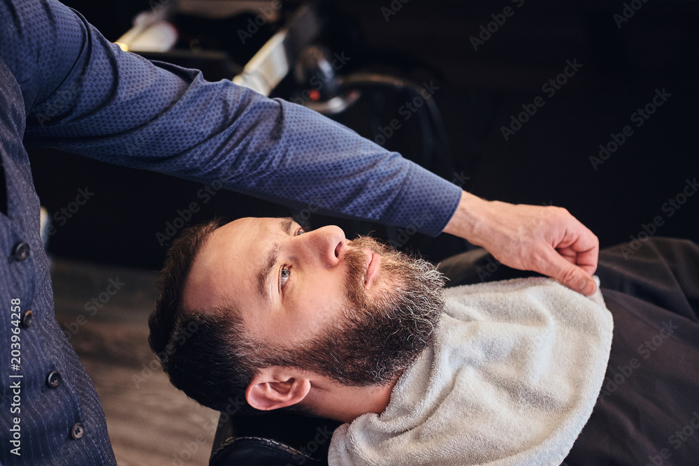 Master hairdresser prepares the face for shaving in the barber shop. Master hairdresser prepares the face for shaving in the barber shop.
