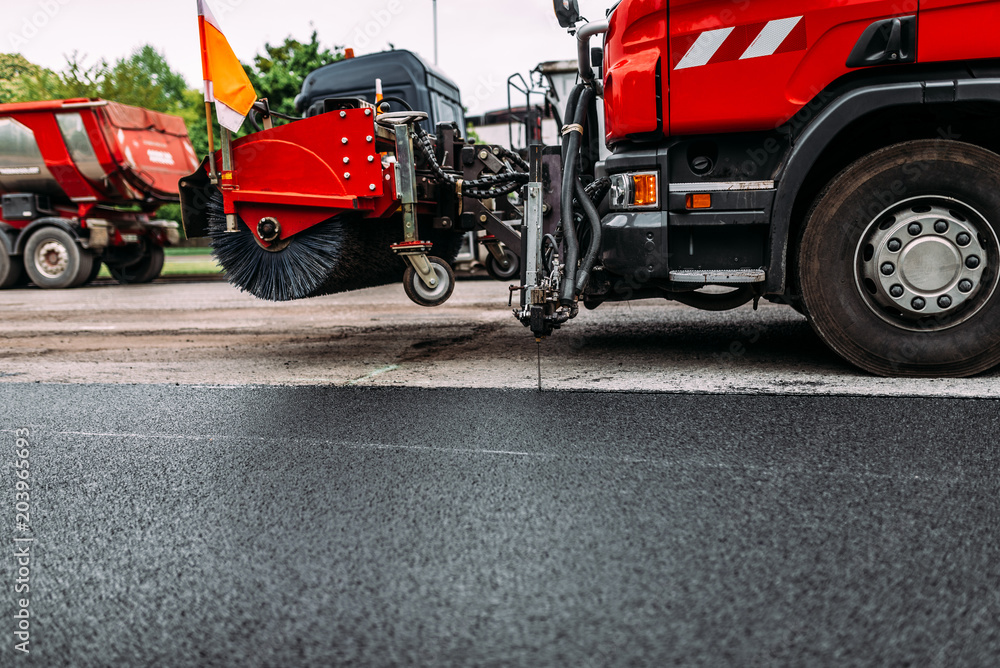 Road repair work. Dusting machine while repairing road. Street cleaning machine.