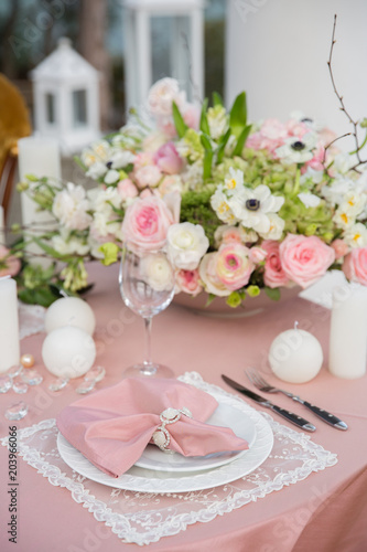 Beautiful wedding table that decorated with flower arrangements and candles. © popovich22