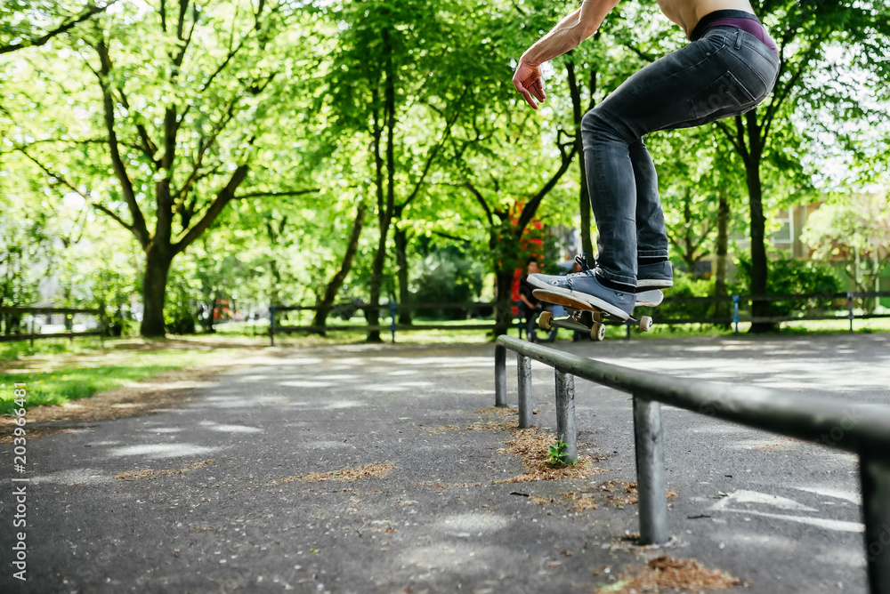 Skateboader jump on the ramp in the park.
