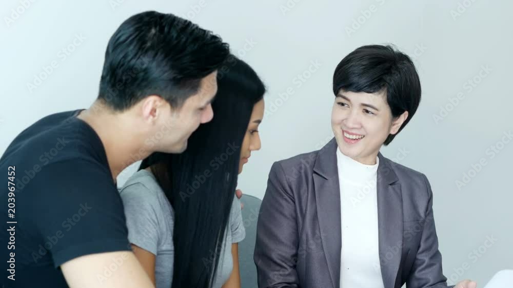 Young Couple Who are looking for Purchasing/ Renting New Home. Professional Real Estate Agent talking to Customer for Contracts. 4K Resolution Young Couple Who are looking for Purchasing/ Renting New Home. Professional Real Estate Agent talking to Customer for Contracts. 4K Resolution