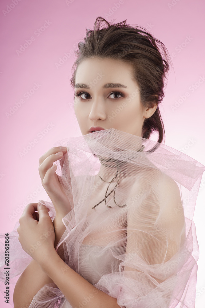 Beautiful charming big breast asian girl wearing a pink wedding veil on her  naked shoulders and a choker on her neck shyly covers her face with a veil  Stock Photo | Adobe