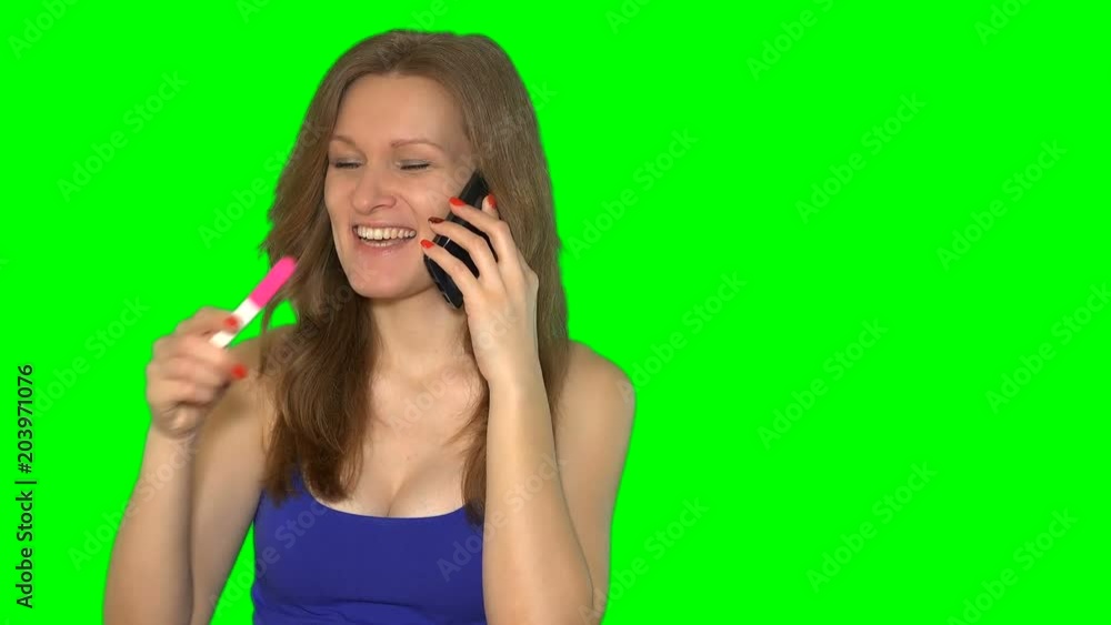 Beautiful girl with pregnancy test talking on cell phone Beautiful girl with pregnancy test talking on cell phone