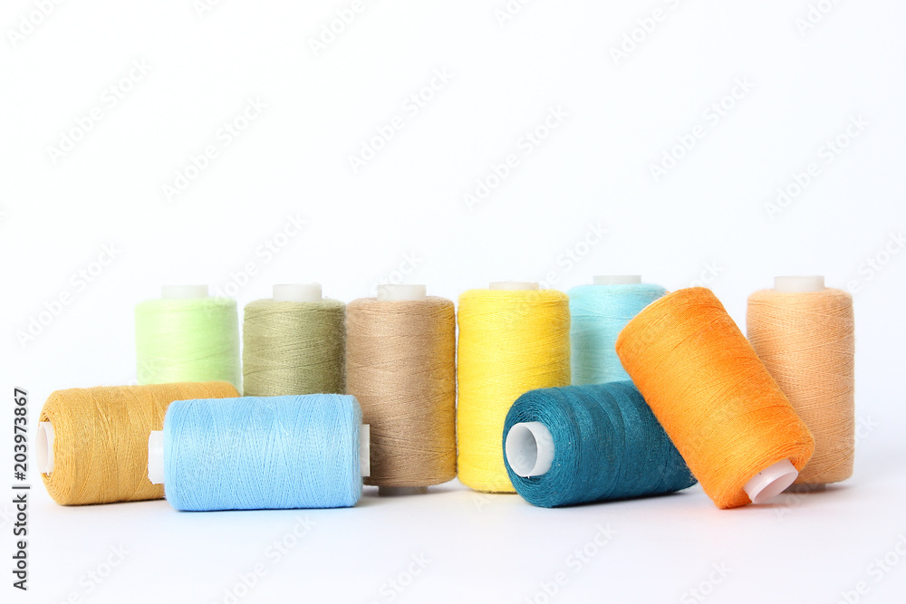 sewing thread of different colors isolated on white. sewing thread of different colors isolated on white.