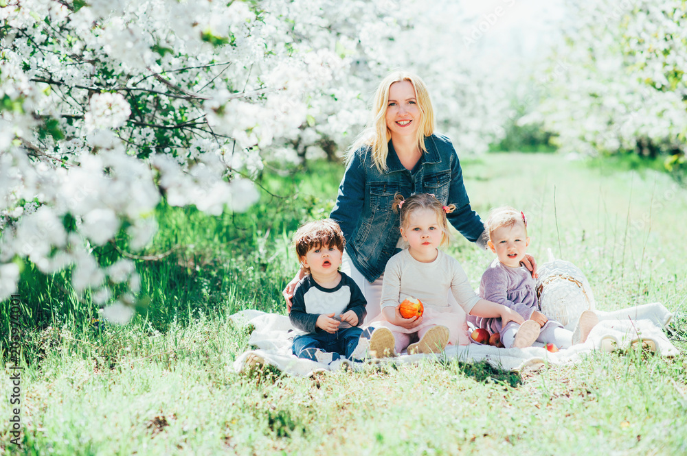 Large Happy cheerful mother with kids daughters and son hug play and enjoy time outdoor in blossom park. Family values Relationship Togetherness Holidays Lifestyle People Love Large Happy cheerful mother with kids daughters and son hug play and enjoy time outdoor in blossom park. Family values Relationship Togetherness Holidays Lifestyle People Love