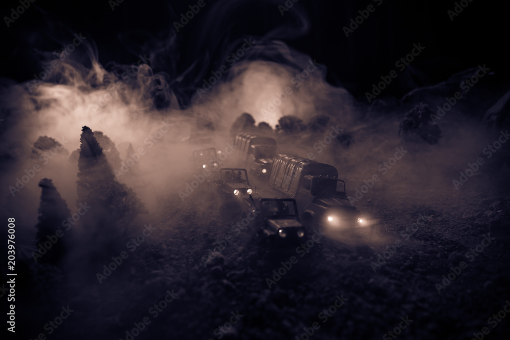 War Concept. Military silhouettes fighting scene on war fog sky background, World War Soldiers Silhouettes Below Cloudy Skyline At night. Attack scene. Selective focus Tanks battle. Decoration