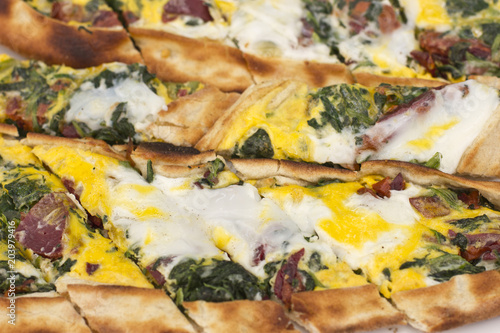 Turkish tortilla pita with bacon pastreurage, eggs and green herbs.