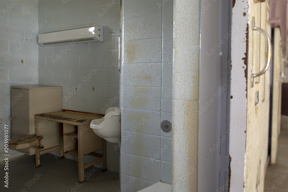 Cell through open door in jail Cell through open door in jail