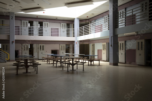 Fototapeta Abandoned jail common room in cell block