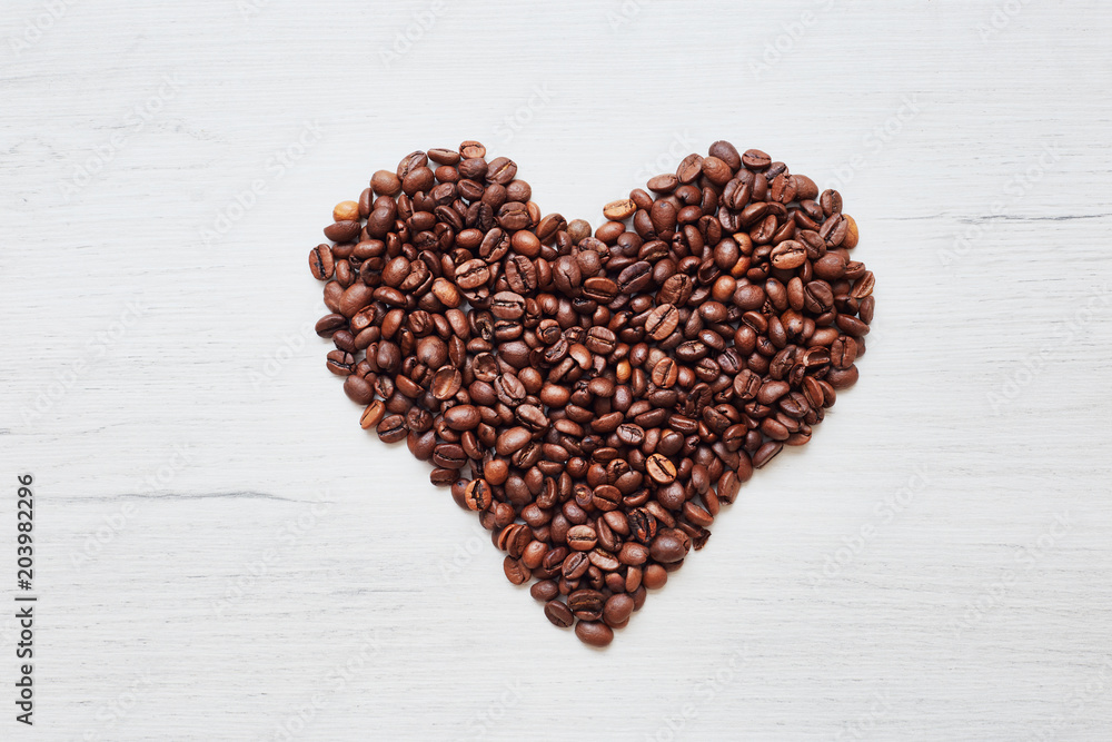 Heart from coffee beans on wooden background Heart from coffee beans on wooden background