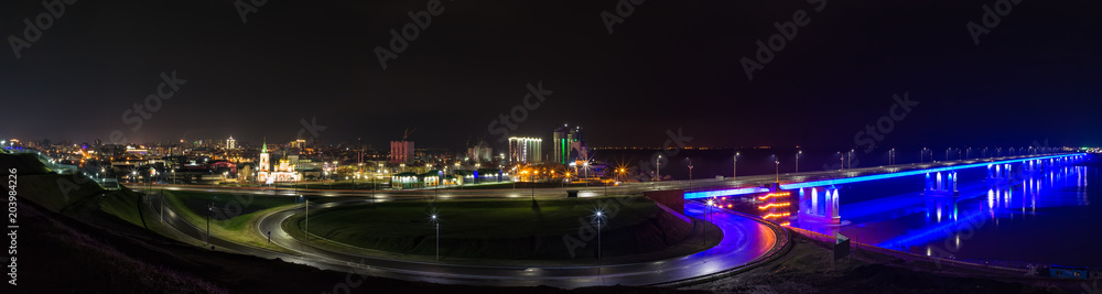 Night panorama of a bridge lit up in the darkness and Barnaul city