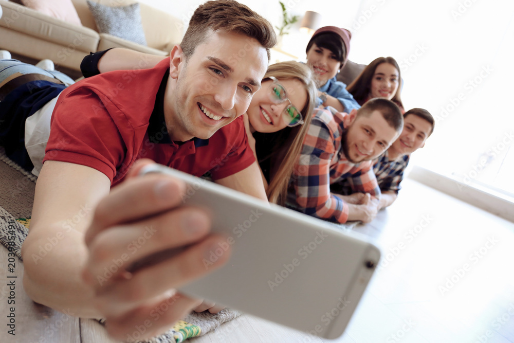 Fototapeta premium Happy friends taking selfie indoors
