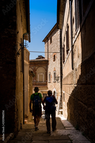 SERRE di RAPOLANO, TUSCANY, Italy - unknown people walking along the narrow streets