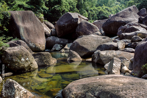 Photo of a mountain river in China among large stones.