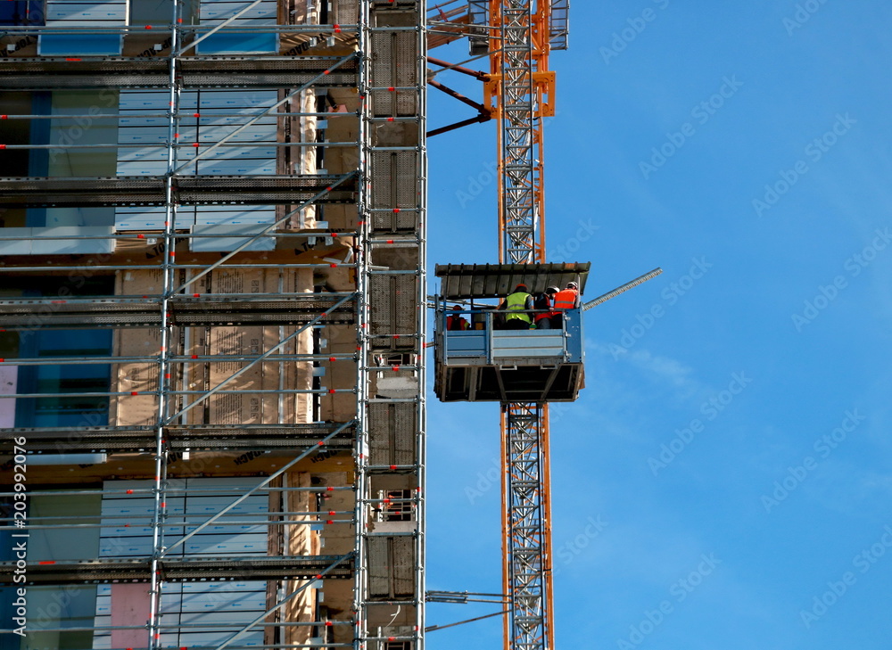 Workers in an elevator at the construction site