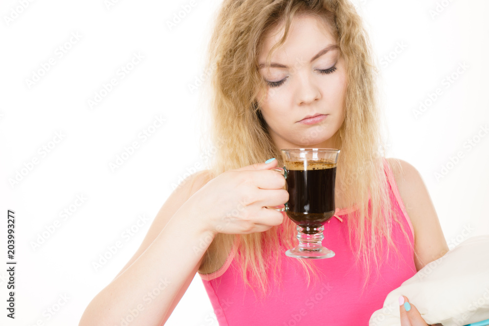 Tired woman drinking her morning coffee Tired woman drinking her morning coffee