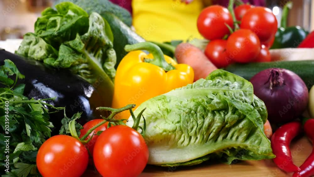 Close up of various healthy vegetables captured in slow motion on kitchen table. Natural dieting food concept. Close up of various healthy vegetables captured in slow motion on kitchen table. Natural dieting food concept.