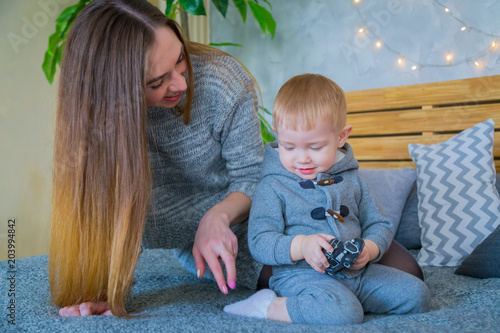 Happy young mother and her baby son playing togerher photo