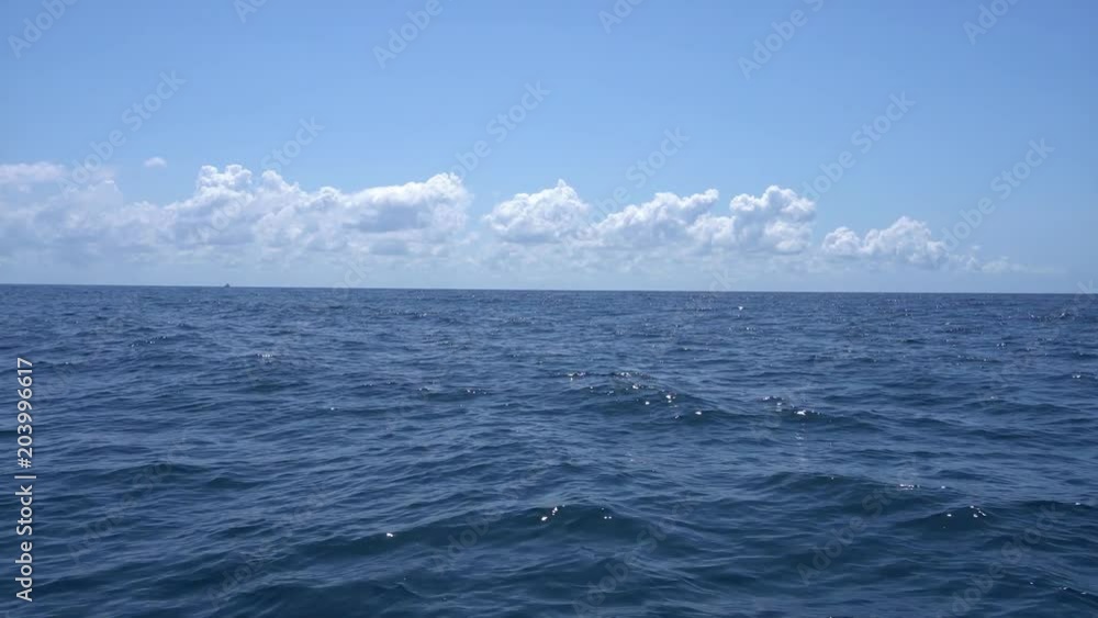 View from the boat floating on the waves in the warm Caribbean Sea. Cancun Mexico. Summer sunny day, blue sky with clouds. View from the boat floating on the waves in the warm Caribbean Sea. Cancun Mexico. Summer sunny day, blue sky with clouds.