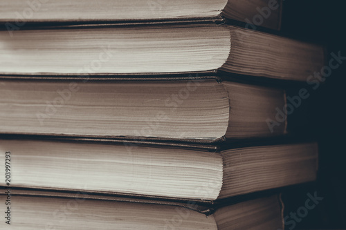 vertical stack of books background toned