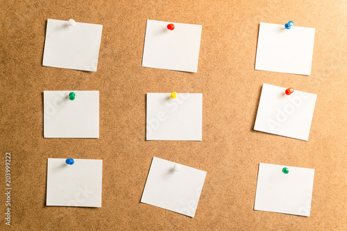 nine white stickers for taking notes on a cardboard background