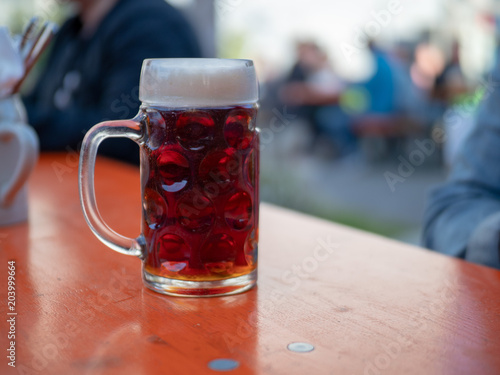 German beer mug sitting on table at outdoor event photo