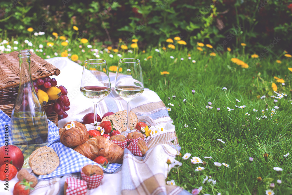 Picnic in the park. A green meadow with flowers, a plaid and a bottle of  wine. Romantic dinner in nature. Spring in the Netherlands. Photos | Adobe  Stock