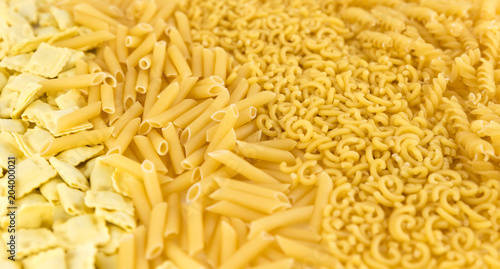 variety of raw pasta: curls, fideuá, macaroni and pasta stuffed with meat