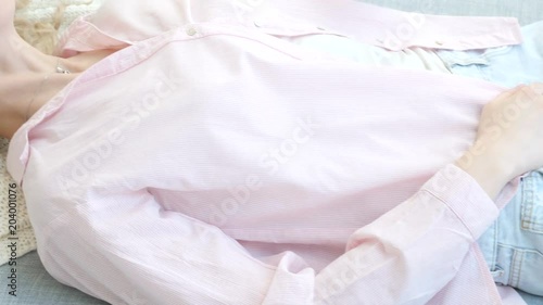 Wallpaper Mural Young blonde woman lying on sofa and posing for photos, girl in casual clothes sits on sofa Torontodigital.ca