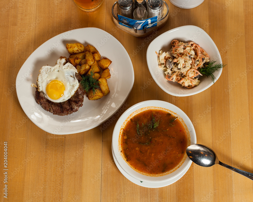 big lunch with soup and fried meat