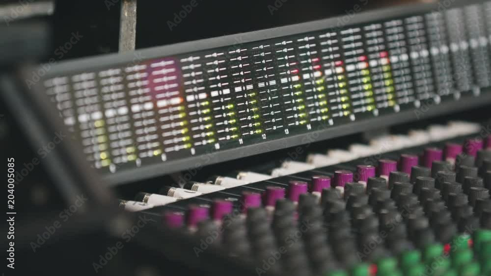 Close Up Audio Board to Bouncing Meters. hand held close up of an audio board tilting up to the audio meters bouncing to a recording Close Up Audio Board to Bouncing Meters. hand held close up of an audio board tilting up to the audio meters bouncing to a recording