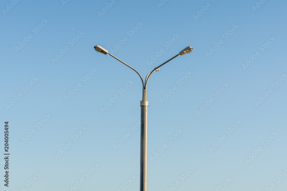 Street lamp post on blue sky background