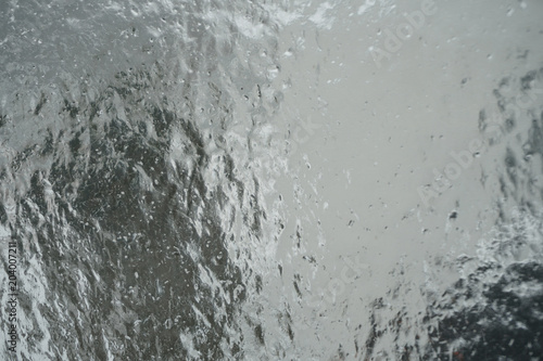 Surface of window after winter storm covered with ice, abstract natual background