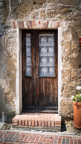 Old wooden door in an italian medieval village. © isaac74