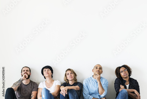 Diverse people sitting with thoughtful face expression