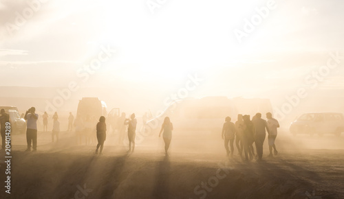 people in the desert with dust