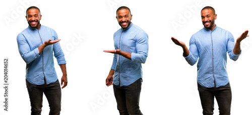 Photos African american man with beard holding something in empty hand