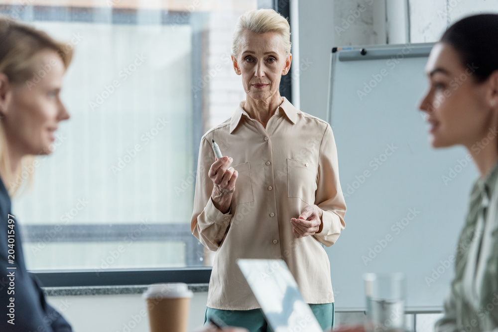 grey hair businesswoman at meeting in office grey hair businesswoman at meeting in office