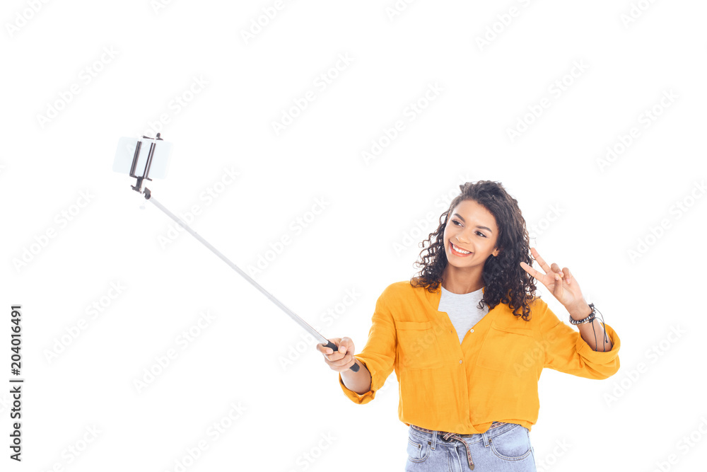 portrait of smiling african american teenager taking selfie on smartphone isolated on white portrait of smiling african american teenager taking selfie on smartphone isolated on white