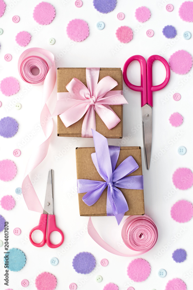 Two gift boxes on festive pastel confetti background. Two gift boxes on festive pastel confetti background.