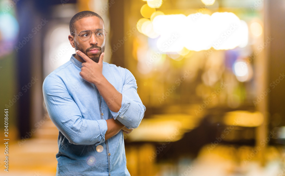 African american man with beard doubt expression, confuse and wonder concept, uncertain future at night African american man with beard doubt expression, confuse and wonder concept, uncertain future at night